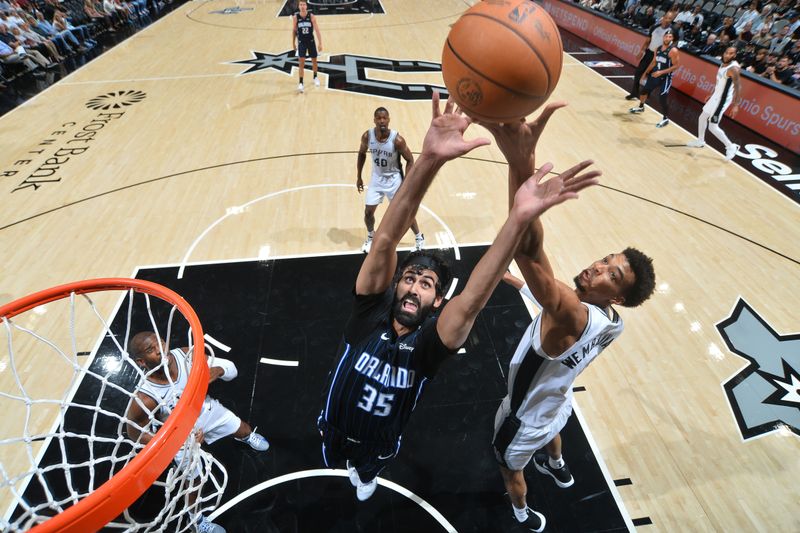 SAN ANTONIO, TX - OCTOBER 9: Victor Wembanyama #1 of the San Antonio Spurs blocks Goga Bitadze #35 of the Orlando Magic during a NBA preseason game on October 9, 2024 at the Frost Bank Center in San Antonio, Texas. NOTE TO USER: User expressly acknowledges and agrees that, by downloading and or using this photograph, user is consenting to the terms and conditions of the Getty Images License Agreement. Mandatory Copyright Notice: Copyright 2024 NBAE (Photos by Michael Gonzales/NBAE via Getty Images)