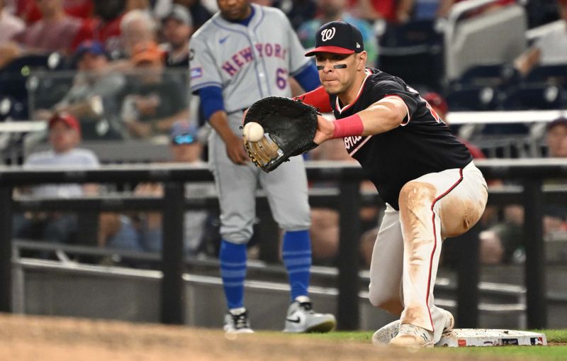 Jul 2, 2024; Washington, District of Columbia, USA; Washington Nationals first baseman Joey Meneses (45) catches the ball at first base for an out against the New York Mets during the ninth inning at Nationals Park. Mandatory Credit: Rafael Suanes-USA TODAY Sports