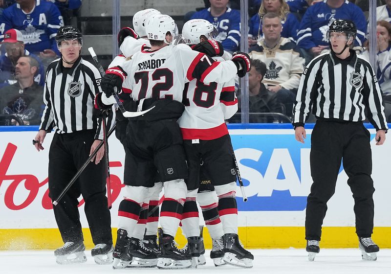 Apr 29, 2025; Toronto, Ontario, CAN; Ottawa Senators center Tim Stützle (18) celebrates with defenseman Thomas Chabot (72) and teammates after scoring against the Toronto Maple Leafs in the third period during game five of the first round of the 2025 Stanley Cup Playoffs at Scotiabank Arena. Mandatory Credit: Nick Turchiaro-Imagn Images