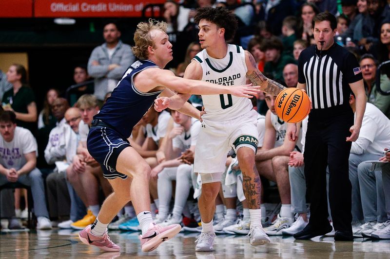 Mar 1, 2025; Fort Collins, Colorado, USA; Colorado State Rams guard Kyan Evans (0) controls the ball under pressure from Utah State Aggies guard Jordy Barnes (5) in the second half at Moby Arena. Mandatory Credit: Isaiah J. Downing-Imagn Images