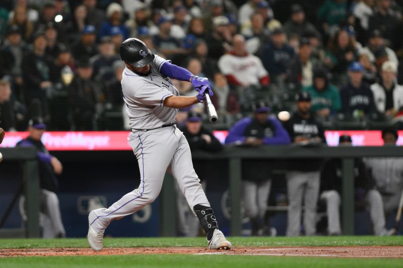 Apr 15, 2023; Seattle, Washington, USA; Colorado Rockies catcher Elias Diaz hits a single against the Seattle Mariners during the second inning at T-Mobile Park. Mandatory Credit: Steven Bisig-USA TODAY Sports