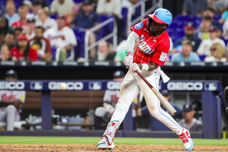 Sep 16, 2023; Miami, Florida, USA; Miami Marlins center fielder Jazz Chisholm Jr. (2) hits a grand slam against the Atlanta Braves during the eighth inning at loanDepot Park. Mandatory Credit: Sam Navarro-USA TODAY Sports