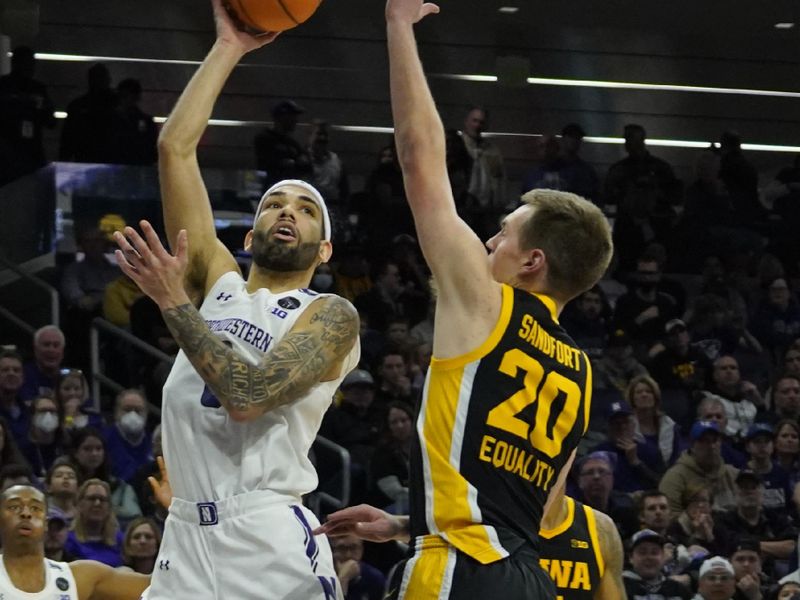 Feb 19, 2023; Evanston, Illinois, USA; Northwestern Wildcats guard Boo Buie (0) shoots over Iowa Hawkeyes forward Payton Sandfort (20) during the second half at Welsh-Ryan Arena. Mandatory Credit: David Banks-USA TODAY Sports