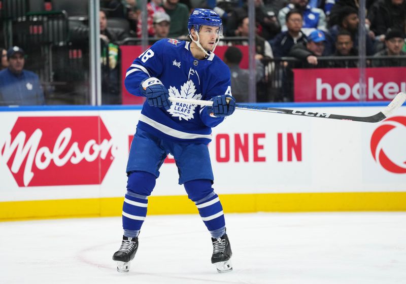 Dec 9, 2023; Toronto, Ontario, CAN; Toronto Maple Leafs defenseman Maxime Lajoie (48) skates passes the puck against the Nashville Predators during the second period at Scotiabank Arena. Mandatory Credit: Nick Turchiaro-USA TODAY Sports