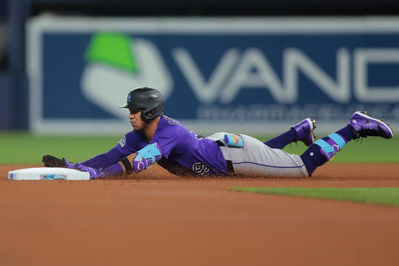 Jun 4, 2025; Miami, Florida, USA; Colorado Rockies second baseman Thairo Estrada (39) slides onto second base after hitting a double against the Miami Marlins during the first inning at loanDepot Park. Mandatory Credit: Sam Navarro-Imagn Images