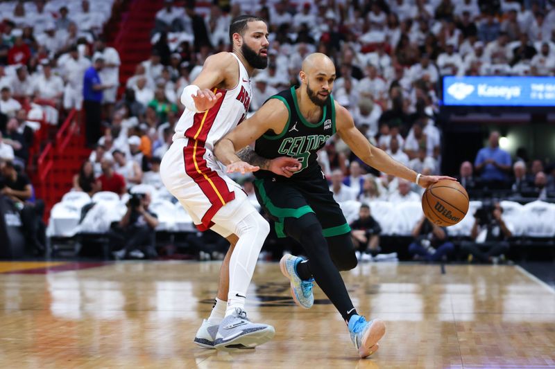 MIAMI, FLORIDA - APRIL 27: Derrick White #9 of the Boston Celtics drives against Caleb Martin #16 of the Miami Heat during the first quarter in game three of the Eastern Conference First Round Playoffs at Kaseya Center on April 27, 2024 in Miami, Florida.  NOTE TO USER: User expressly acknowledges and agrees that, by downloading and or using this photograph, User is consenting to the terms and conditions of the Getty Images License Agreement. (Photo by Megan Briggs/Getty Images)