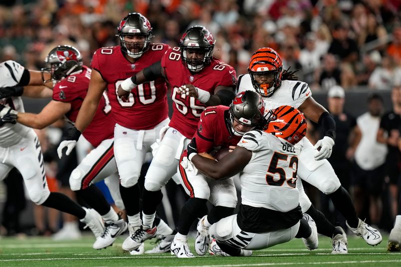 Cincinnati Bengals defensive tackle Travis Bell (53) sacks Tampa Bay Buccaneers quarterback John Wolford (11) for a 6-yard loss in the second half of an NFL preseason football game Saturday, Aug. 10, 2024, in Cincinnati. (AP Photo/Carolyn Kaster)