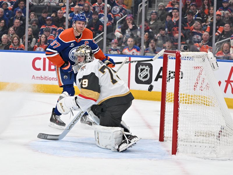 Dec 21, 2025; Edmonton, Alberta, CAN; Edmonton Oilers center Connor McDavid (97) tries to get the puck past Vegas Golden Knights goalie Carter Hart (79) during the first period at Rogers Place. Mandatory Credit: Walter Tychnowicz-Imagn Images