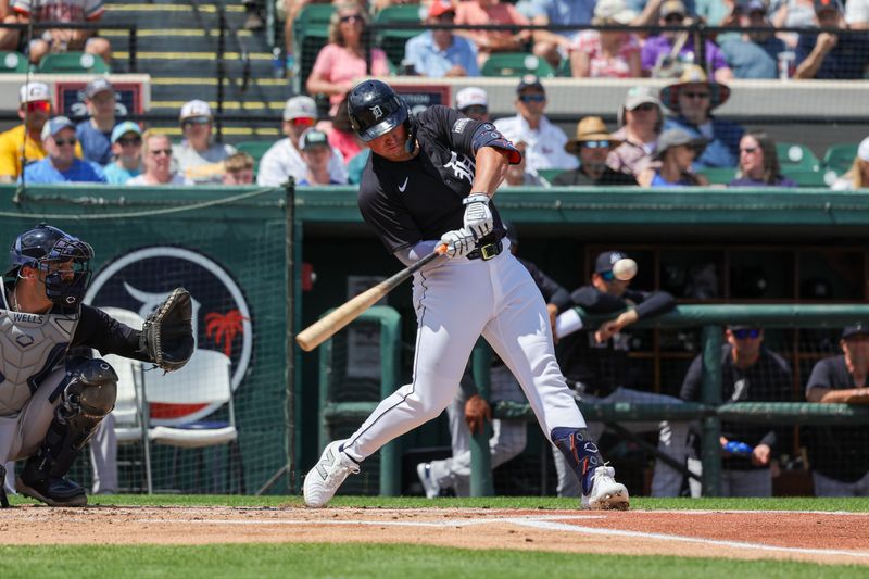 Mar 23, 2024; Lakeland, Florida, USA; Detroit Tigers designated hitter Spencer Torkelson (20) hits an RBI single during the first inning against the New York Yankees at Publix Field at Joker Marchant Stadium. Mandatory Credit: Mike Watters-USA TODAY Sports