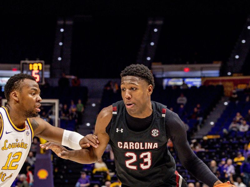 Feb 18, 2023; Baton Rouge, Louisiana, USA; South Carolina Gamecocks forward Gregory Jackson II (23) dribbles against LSU Tigers forward KJ Williams (12) during the second half at Pete Maravich Assembly Center. Mandatory Credit: Stephen Lew-USA TODAY Sports