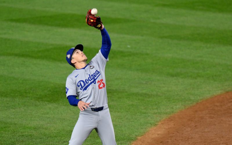 Oct 29, 2024; New York, New York, USA; Los Angeles Dodgers outfielder Tommy Edman (25) makes a catch during the third inning against the New York Yankees in game four of the 2024 MLB World Series at Yankee Stadium. Mandatory Credit: John Jones-Imagn Images