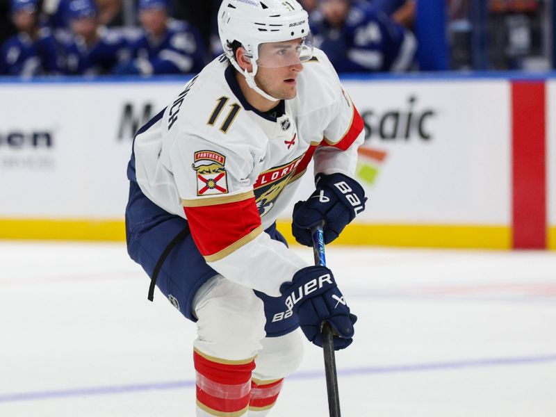 Oct 2, 2025; Tampa, Florida, USA; Florida Panthers right wing Mackie Samoskevich (11) controls the puck against the Tampa Bay Lightning in the second period at Benchmark International Arena. Mandatory Credit: Nathan Ray Seebeck-Imagn Images