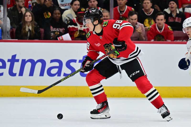 Nov 21, 2024; Chicago, Illinois, USA; Chicago Blackhawks center Connor Bedard (98) plays the puck against the Florida Panthers during the first period at the United Center. Mandatory Credit: Daniel Bartel-Imagn Images