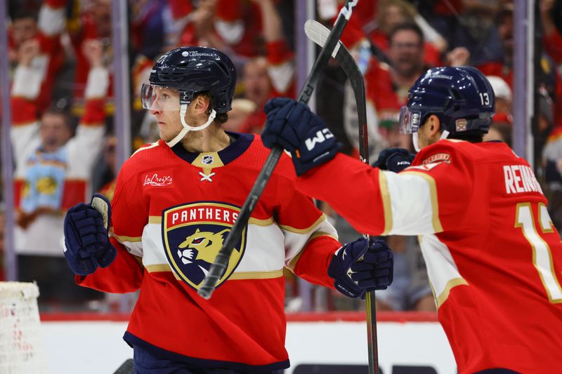 May 8, 2024; Sunrise, Florida, USA; Florida Panthers center Eetu Luostarinen (27) celebrates with center Sam Reinhart (13) after scoring against the Boston Bruins during the third period in game two of the second round of the 2024 Stanley Cup Playoffs at Amerant Bank Arena. Mandatory Credit: Sam Navarro-USA TODAY Sports