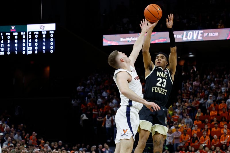 Feb 17, 2024; Charlottesville, Virginia, USA; Wake Forest Demon Deacons guard Hunter Sallis (23) shoots the ball as Virginia Cavaliers guard Isaac McKneely (11) defends in the first half at John Paul Jones Arena. Mandatory Credit: Geoff Burke-USA TODAY Sports