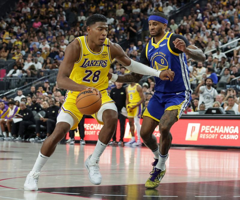 LAS VEGAS, NEVADA - OCTOBER 15: Rui Hachimura #28 of the Los Angeles Lakers drives against Gary Payton II #0 of the Golden State Warriors in the fourth quarter of their preseason game at T-Mobile Arena at T-Mobile Arena on October 15, 2024 in Las Vegas, Nevada. The Warriors defeated the Lakers 111-97. NOTE TO USER: User expressly acknowledges and agrees that, by downloading and or using this photograph, User is consenting to the terms and conditions of the Getty Images License Agreement. (Photo by Ethan Miller/Getty Images)