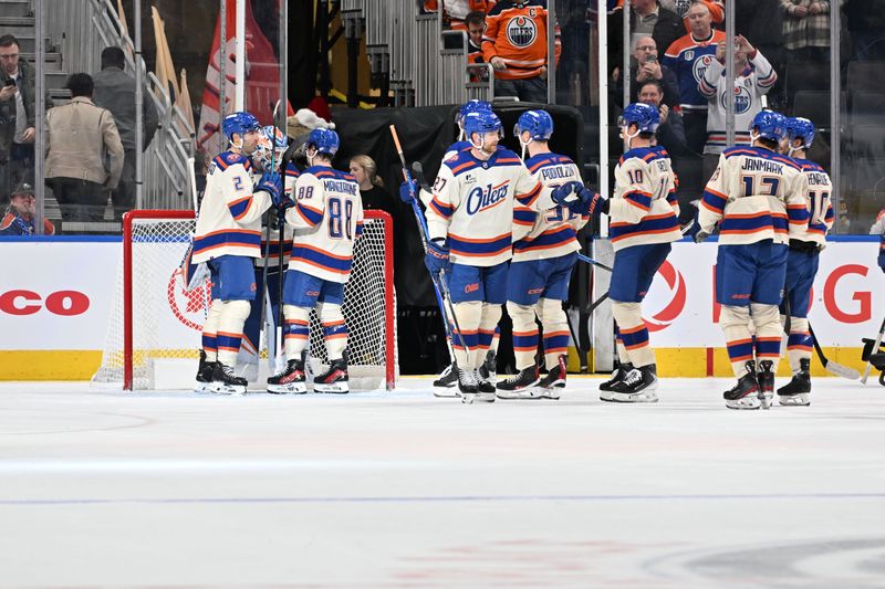 Dec 4, 2025; Edmonton, Alberta, CAN;  Edmonton Oilers defenseman Evan Bouchard (2) with Oilers left winger Andrew Mangiapane (88) clebrates their win with Edmonton Oilers goalie Calvin Pickard (30) over the Seattle Kraken during the third period at Rogers Place. Mandatory Credit: Walter Tychnowicz-Imagn Images