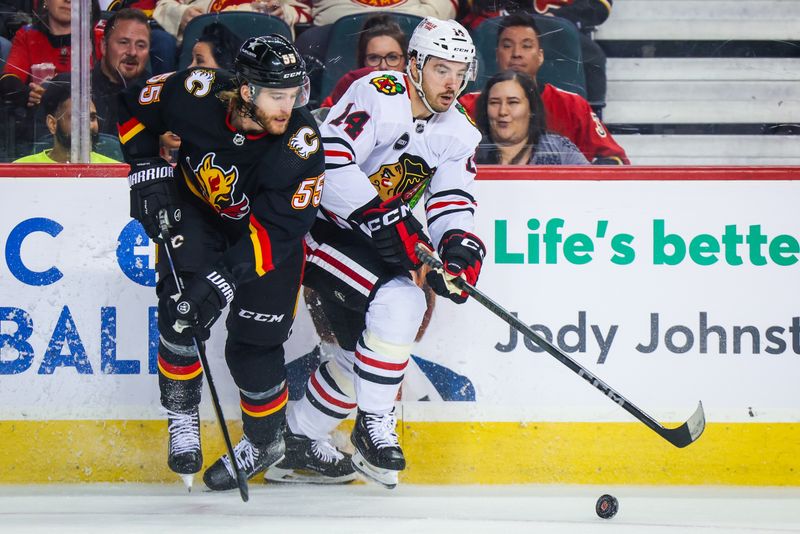 Jan 27, 2024; Calgary, Alberta, CAN; Chicago Blackhawks left wing Boris Katchouk (14) and Calgary Flames defenseman Noah Hanifin (55) battles for the puck during the third period at Scotiabank Saddledome. Mandatory Credit: Sergei Belski-USA TODAY Sports