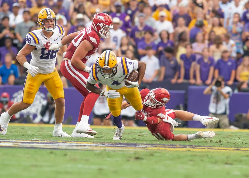 Sep 23, 2023; Baton Rouge, Louisiana, USA; Arkansas Razorbacks defensive back Hudson Clark (17) makes a takcle against LSU Tigers running back John Emery Jr. (4) during the game at Tiger Stadium. Mandatory Credit: Scott Clause-USA TODAY Sports