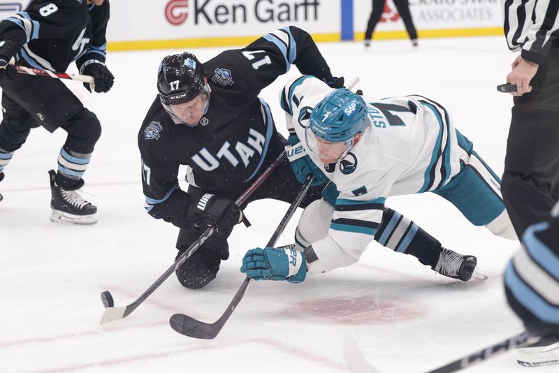 Oct 28, 2024; Salt Lake City, Utah, USA; Utah Hockey Club center Nick Bjugstad (17) and San Jose Sharks center Nico Sturm (7) fight for the puck after a face-off during the first period at Delta Center. Mandatory Credit: Chris Nicoll-Imagn Images