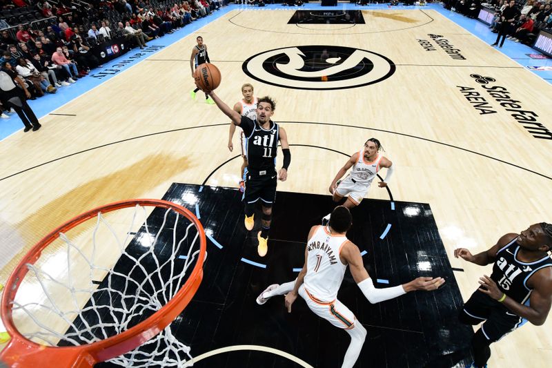 ATLANTA, GA - JANUARY 15: Trae Young #11 of the Atlanta Hawks drives to the basket during the game against the San Antonio Spurs on January 15, 2024 at State Farm Arena in Atlanta, Georgia.  NOTE TO USER: User expressly acknowledges and agrees that, by downloading and/or using this Photograph, user is consenting to the terms and conditions of the Getty Images License Agreement. Mandatory Copyright Notice: Copyright 2024 NBAE (Photo by Adam Hagy/NBAE via Getty Images)