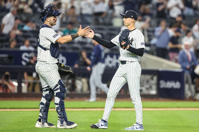 May 22, 2024; Bronx, New York, USA;  New York Yankees catcher Austin Wells (28) and relief pitcher Luke Weaver (30) celebrate after defeating the Seattle Mariners 7-3 at Yankee Stadium. Mandatory Credit: Wendell Cruz-USA TODAY Sports