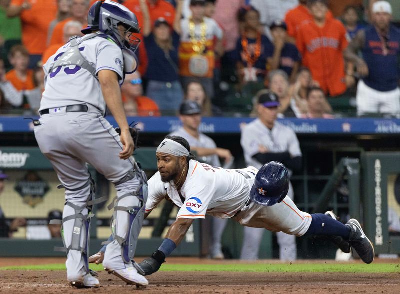 Jul 5, 2023; Houston, Texas, USA; Houston Astros left fielder Corey Julks (9) scores against Colorado Rockies catcher Elias Diaz (35) on a double by Houston second baseman Mauricio Dubon (not pictured) in the seventh inning at Minute Maid Park. Mandatory Credit: Thomas Shea-USA TODAY Sports