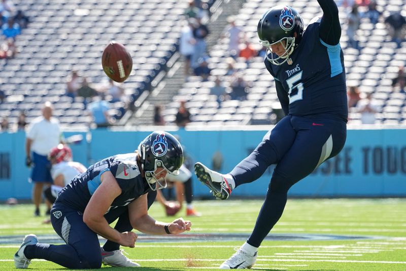 Tennessee Titans place-kicker Nick Folk, right, kicks a field goal as punter Ryan Stonehouse, left, holds before an NFL football game against the Cincinnati Bengals, Sunday, Oct. 1, 2023, in Nashville, Tenn. (AP Photo/George Walker IV)