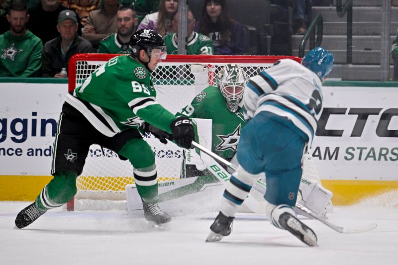 Nov 20, 2024; Dallas, Texas, USA; Dallas Stars goaltender Jake Oettinger (29) stops a shot by San Jose Sharks center Will Smith (2) as defenseman Thomas Harley (55) looks on during the second period at the American Airlines Center. Mandatory Credit: Jerome Miron-Imagn Images