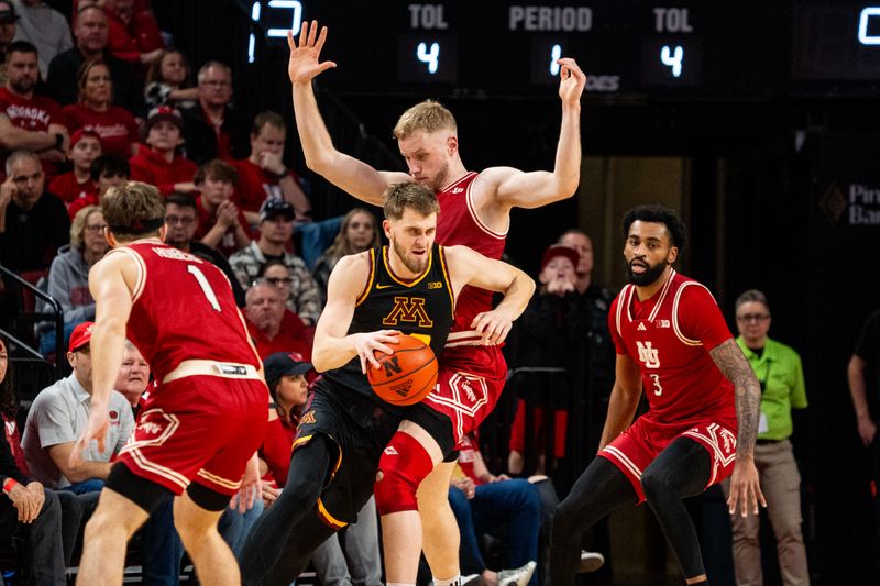 Feb 25, 2024; Lincoln, Nebraska, USA; Minnesota Golden Gophers forward Parker Fox (23) drives against Nebraska Cornhuskers forward Rienk Mast (51) during the first half at Pinnacle Bank Arena. Mandatory Credit: Dylan Widger-USA TODAY Sports