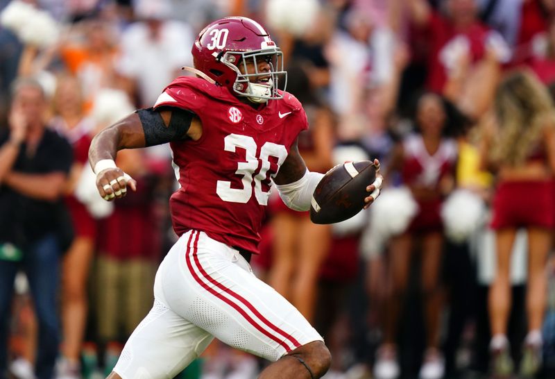 Oct 21, 2023; Tuscaloosa, Alabama, USA; Alabama Crimson Tide linebacker Jihaad Campbell (30) picks up a fumble and ran it back for a touchdown against the Tennessee Volunteers during the second half at Bryant-Denny Stadium. Mandatory Credit: John David Mercer-USA TODAY Sports