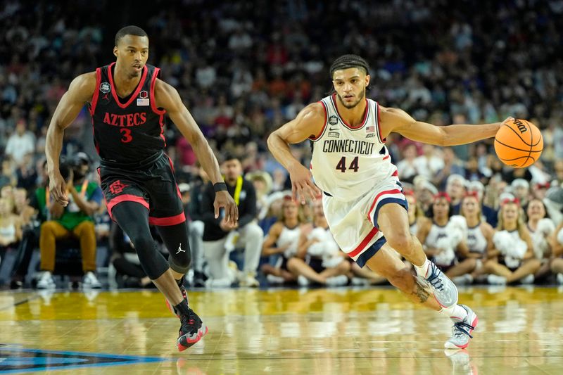 Apr 3, 2023; Houston, TX, USA; Connecticut Huskies guard Andre Jackson Jr. (44) dribbles the ball against San Diego State Aztecs guard Micah Parrish (3) during the first half in the national championship game of the 2023 NCAA Tournament at NRG Stadium. Mandatory Credit: Bob Donnan-USA TODAY Sports