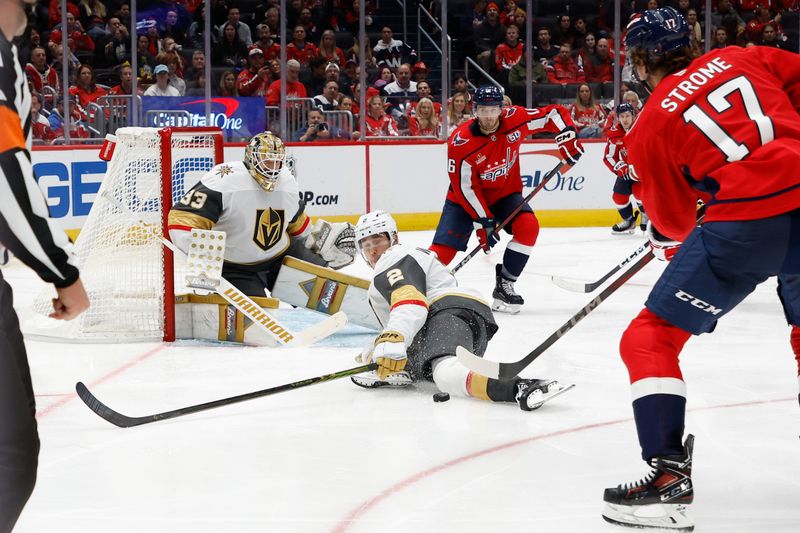 Oct 15, 2024; Washington, District of Columbia, USA; Vegas Golden Knights defenseman Zach Whitecloud (2) blocks a shot on Golden Knights goaltender Adin Hill (33) by Washington Capitals center Dylan Strome (17) in the third period at Capital One Arena. Mandatory Credit: Geoff Burke-Imagn Images