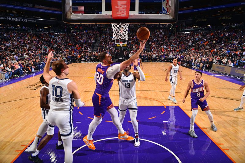 PHOENIX, AZ - JANUARY 7: Jusuf Nurkic #20 of the Phoenix Suns shoots the ball during the game against the Memphis Grizzlies on January 7, 2024 at Footprint Center in Phoenix, Arizona. NOTE TO USER: User expressly acknowledges and agrees that, by downloading and or using this photograph, user is consenting to the terms and conditions of the Getty Images License Agreement. Mandatory Copyright Notice: Copyright 2024 NBAE (Photo by Barry Gossage/NBAE via Getty Images)