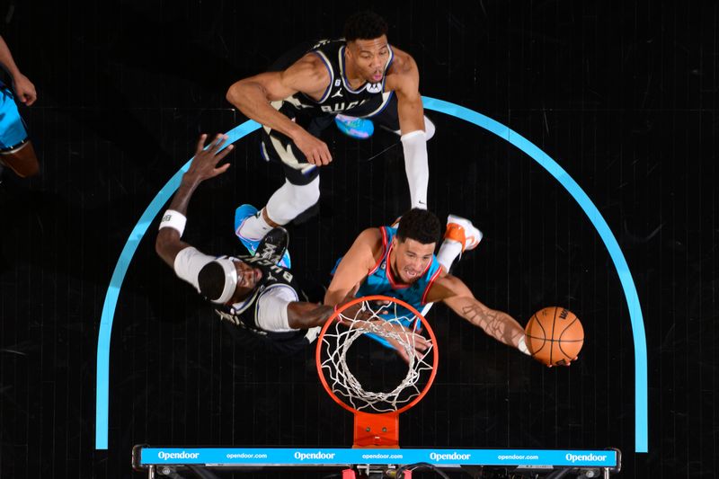 PHOENIX, AZ - MARCH 14: Devin Booker #1 of the Phoenix Suns drives to the basket against the Milwaukee Bucks on March 14, 20223at Footprint Center in Phoenix, Arizona. NOTE TO USER: User expressly acknowledges and agrees that, by downloading and or using this photograph, user is consenting to the terms and conditions of the Getty Images License Agreement. Mandatory Copyright Notice: Copyright 2023 NBAE (Photo by Barry Gossage/NBAE via Getty Images)