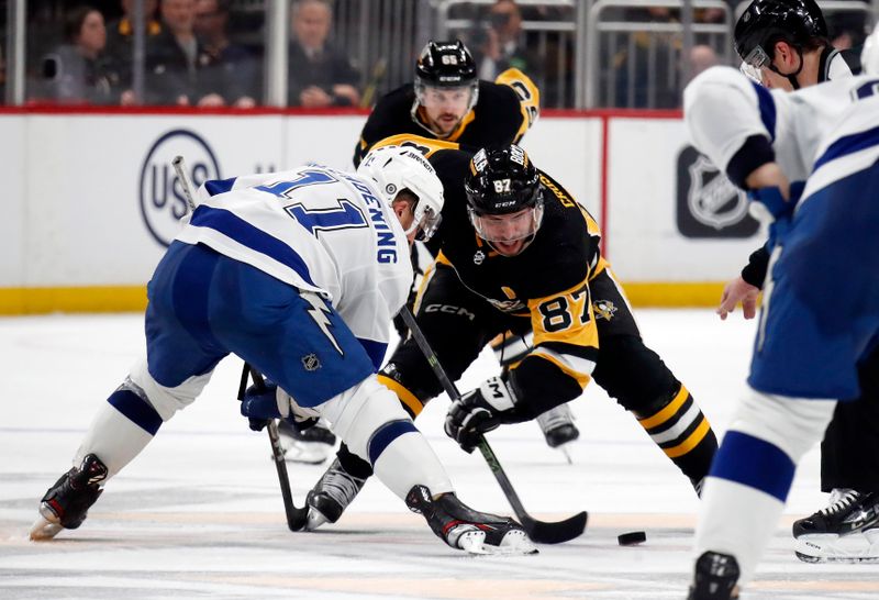 Apr 6, 2024; Pittsburgh, Pennsylvania, USA;  Tampa Bay Lightning center Luke Glendening (11) and Pittsburgh Penguins center Sidney Crosby (87) take a face-off during the third period at PPG Paints Arena. The Penguins won 5-4. Mandatory Credit: Charles LeClaire-USA TODAY Sports