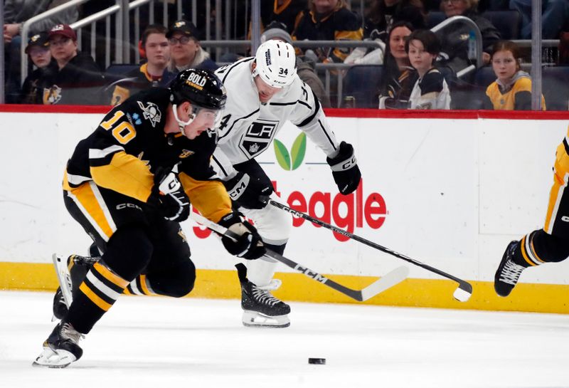 Feb 18, 2024; Pittsburgh, Pennsylvania, USA;  Pittsburgh Penguins left wing Drew O'Connor (10) skates with the puck against the Los Angeles Kings during the first period at PPG Paints Arena. Mandatory Credit: Charles LeClaire-USA TODAY Sports