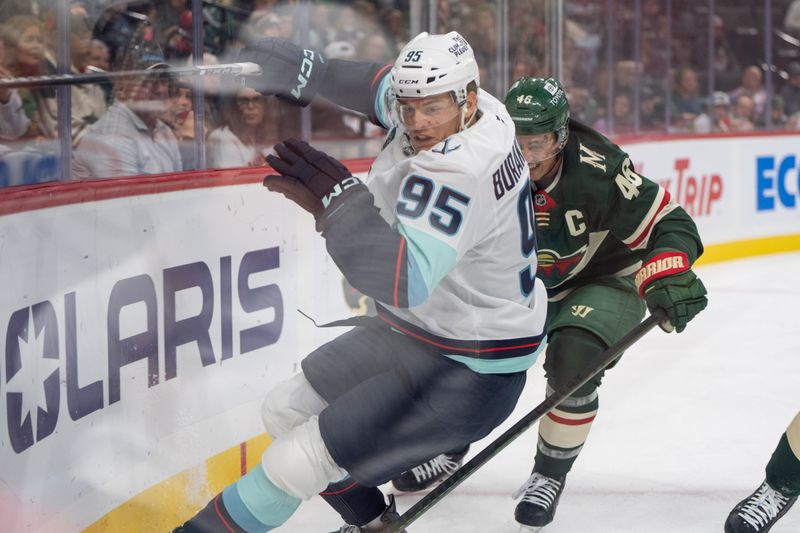 Oct 12, 2024; Saint Paul, Minnesota, USA; Seattle Kraken left wing Andre Burakovsky (95) is checked by Minnesota Wild defenseman Jared Spurgeon (46) in the first period at Xcel Energy Center. Mandatory Credit: Matt Blewett-Imagn Images