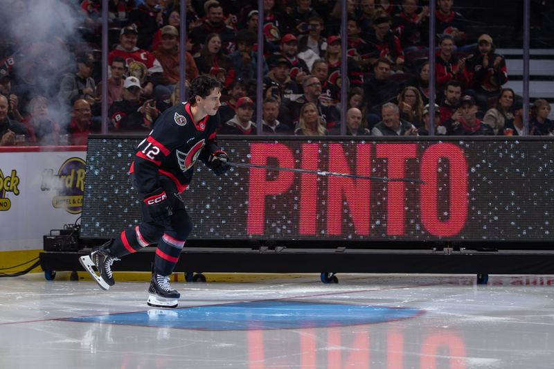 Oct 10, 2024; Ottawa, Ontario, CAN; Ottawa Senators center Shane Pinto (12) is introduced prior to the start of the season opening game against the Florida Panthers at the Canadian Tire Centre. Mandatory Credit: Marc DesRosiers-Imagn Images