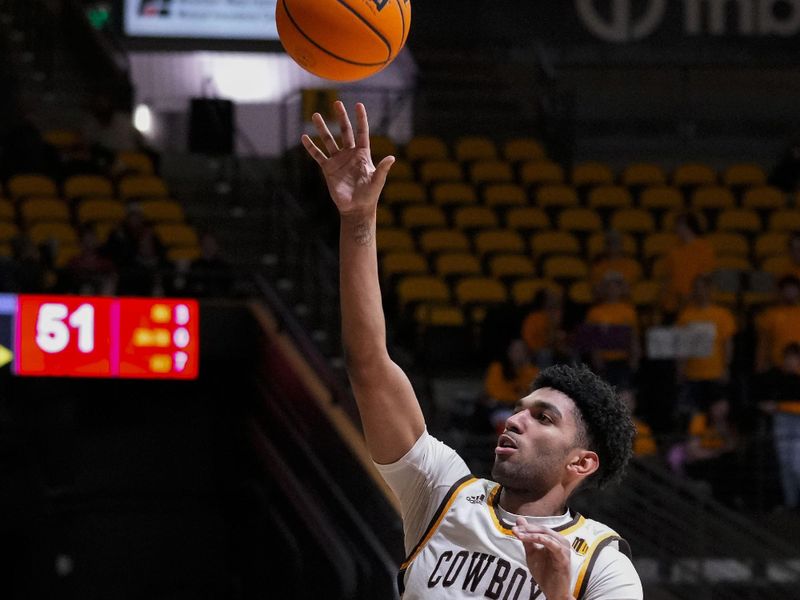 Feb 27, 2024; Laramie, Wyoming, USA; Wyoming Cowboys guard Kael Combs (11) shoots against the UNLV Runnin' Rebels during the second half at Arena-Auditorium. Mandatory Credit: Troy Babbitt-USA TODAY Sports