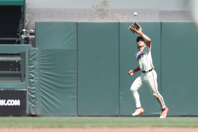 May 21, 2025; San Francisco, California, USA; San Francisco Giants center fielder Jung Hoo Lee (51) catche the ball against the Kansas City Royals during the ninth inning at Oracle Park. Mandatory Credit: Kelley L Cox-Imagn Images