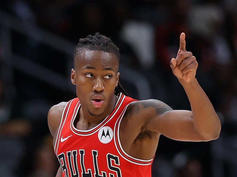 ATLANTA, GEORGIA - FEBRUARY 12:  Ayo Dosunmu #12 of the Chicago Bulls reacts after hitting a three-point basket against the Atlanta Hawks during the second quarter at State Farm Arena on February 12, 2024 in Atlanta, Georgia.  NOTE TO USER: User expressly acknowledges and agrees that, by downloading and/or using this photograph, user is consenting to the terms and conditions of the Getty Images License Agreement.  (Photo by Kevin C. Cox/Getty Images)