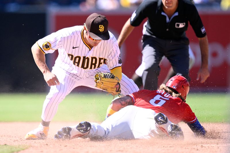 Sep 6, 2023; San Diego, California, USA; Philadelphia Phillies second baseman Bryson Stott (5) steals second base ahead of the tag by San Diego Padres second baseman Ha-seong Kim (7) during the sixth inning at Petco Park. Mandatory Credit: Orlando Ramirez-USA TODAY Sports