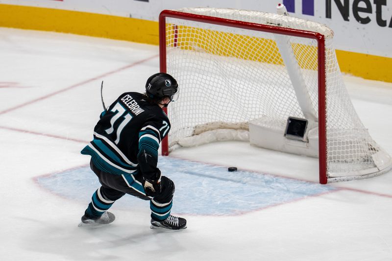 Dec 16, 2025; San Jose, California, USA; San Jose Sharks center Macklin Celebrini (71) scores on the open net during the third period against the Calgary Flames at SAP Center at San Jose. Mandatory Credit: Neville E. Guard-Imagn Images