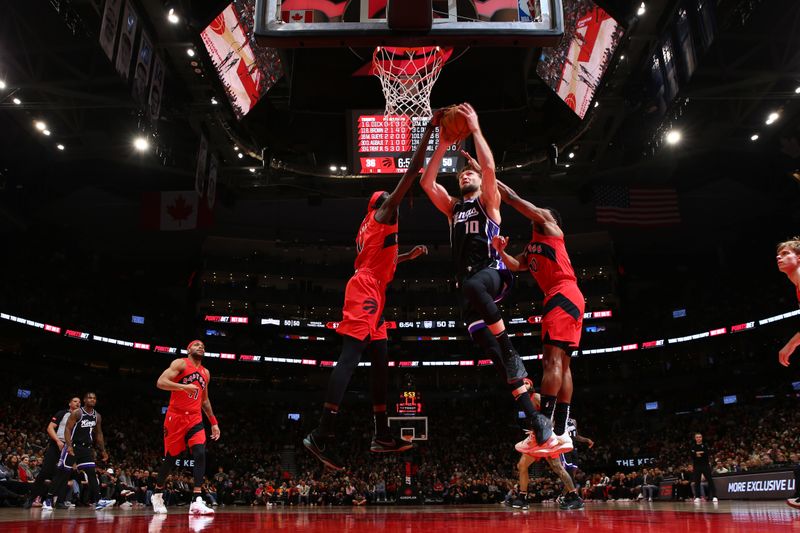 TORONTO, CANADA - MARCH 20: Domantas Sabonis #10 of the Sacramento Kings drives to the basket during the game against the Toronto Raptors on March 20, 2024 at the Scotiabank Arena in Toronto, Ontario, Canada.  NOTE TO USER: User expressly acknowledges and agrees that, by downloading and or using this Photograph, user is consenting to the terms and conditions of the Getty Images License Agreement.  Mandatory Copyright Notice: Copyright 2024 NBAE (Photo by Vaughn Ridley/NBAE via Getty Images)