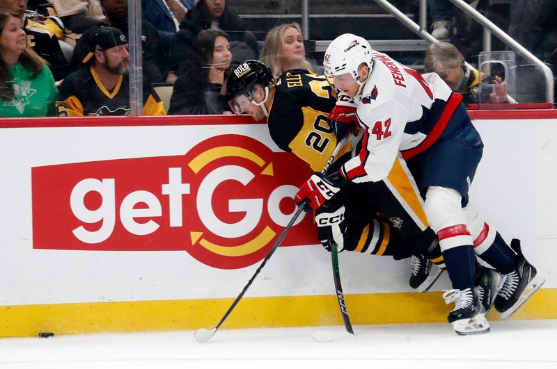 Jan 2, 2024; Pittsburgh, Pennsylvania, USA;  Washington Capitals defenseman Martin Fehervary (42) checks Pittsburgh Penguins center Lars Eller (20) during the first period at PPG Paints Arena. Mandatory Credit: Charles LeClaire-USA TODAY Sports