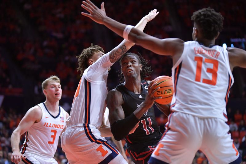 Jan 21, 2024; Champaign, Illinois, USA; Illinois Fighting Illini forward Coleman Hawkins (33) and  forward Quincy Guerrier (13) block Rutgers Scarlet Knights center Clifford Omoruyi (11) on his drive to the basket during the second half at State Farm Center. Mandatory Credit: Ron Johnson-USA TODAY Sports