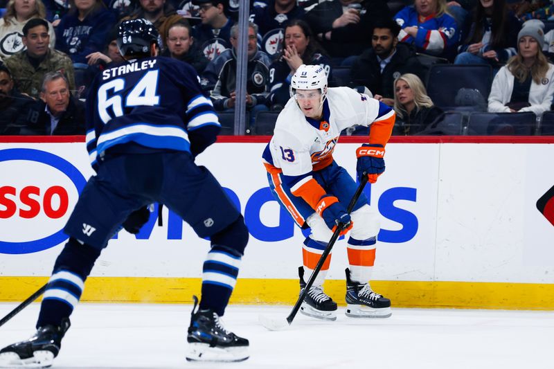 Jan 13, 2026; Winnipeg, Manitoba, CAN; New York Islanders forward Mathew Barzal (13) skates against Winnipeg Jets defenseman Logan Stanley (64) during the first period at Canada Life Centre. Mandatory Credit: Terrence Lee-Imagn Images