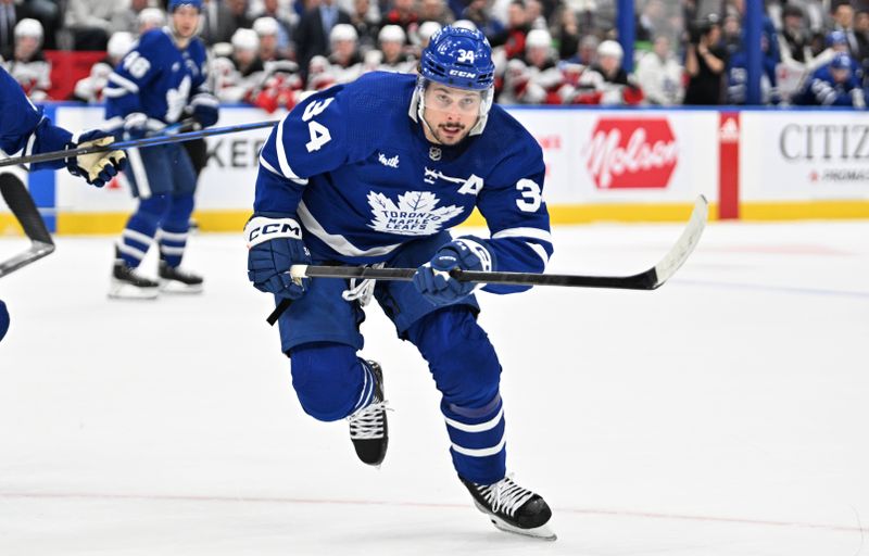 Apr 11, 2024; Toronto, Ontario, CAN; Toronto Maple Leafs forward Auston Matthews (34) pursues the play against the New Jersey Devils in the first period at Scotiabank Arena. Mandatory Credit: Dan Hamilton-USA TODAY Sports