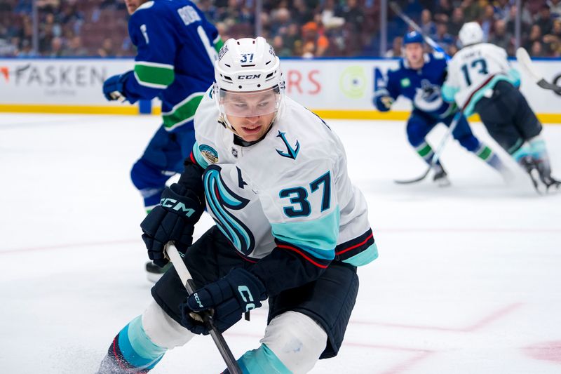 Sep 24, 2024; Vancouver, British Columbia, CAN; Seattle Kraken forward Yanni Gourde (37) looks for the loose puck against the Vancouver Canucks during the first period at Rogers Arena. Mandatory Credit: Bob Frid-Imagn Images